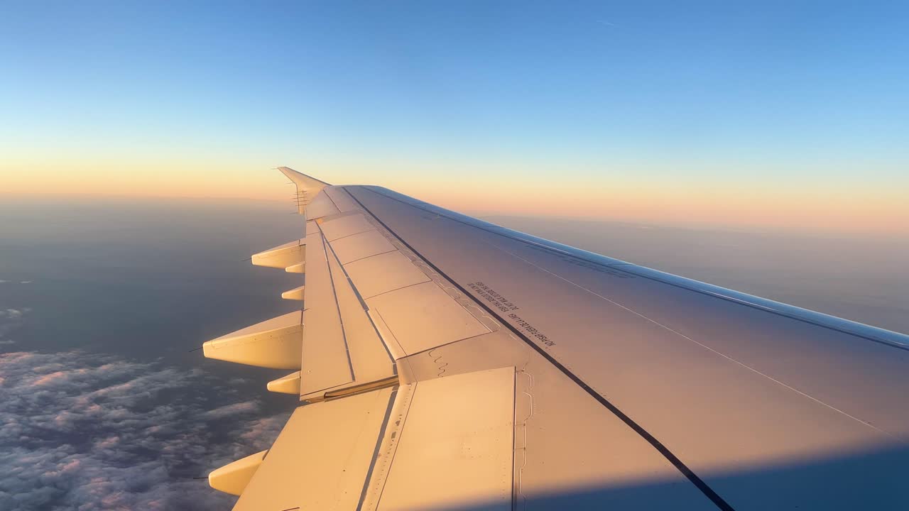 International flight images from the window of the plane flying over the clouds to that of the aircraf