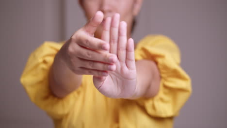 an asian woman stretches and massages her palms