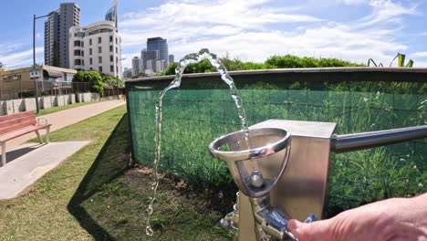 water fountain in use at urban park