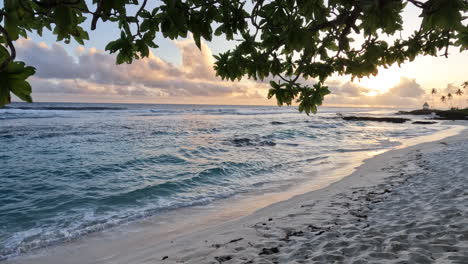 A-beautiful-orange-sunset-over-a-tropical-ocean-and-white-sandy-beach-on-the-island-of-Samoa