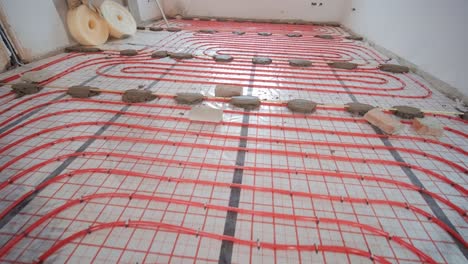 installing underfloor heating pipes for water heating. heating systems. pipes for a heat-insulated floor.