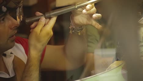 italian goldsmith at work building an engagement or a wedding ring