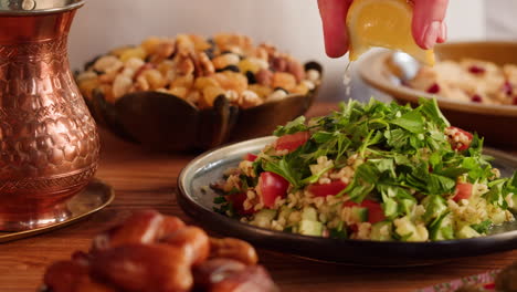 preparing a tabbouleh salad with lemon