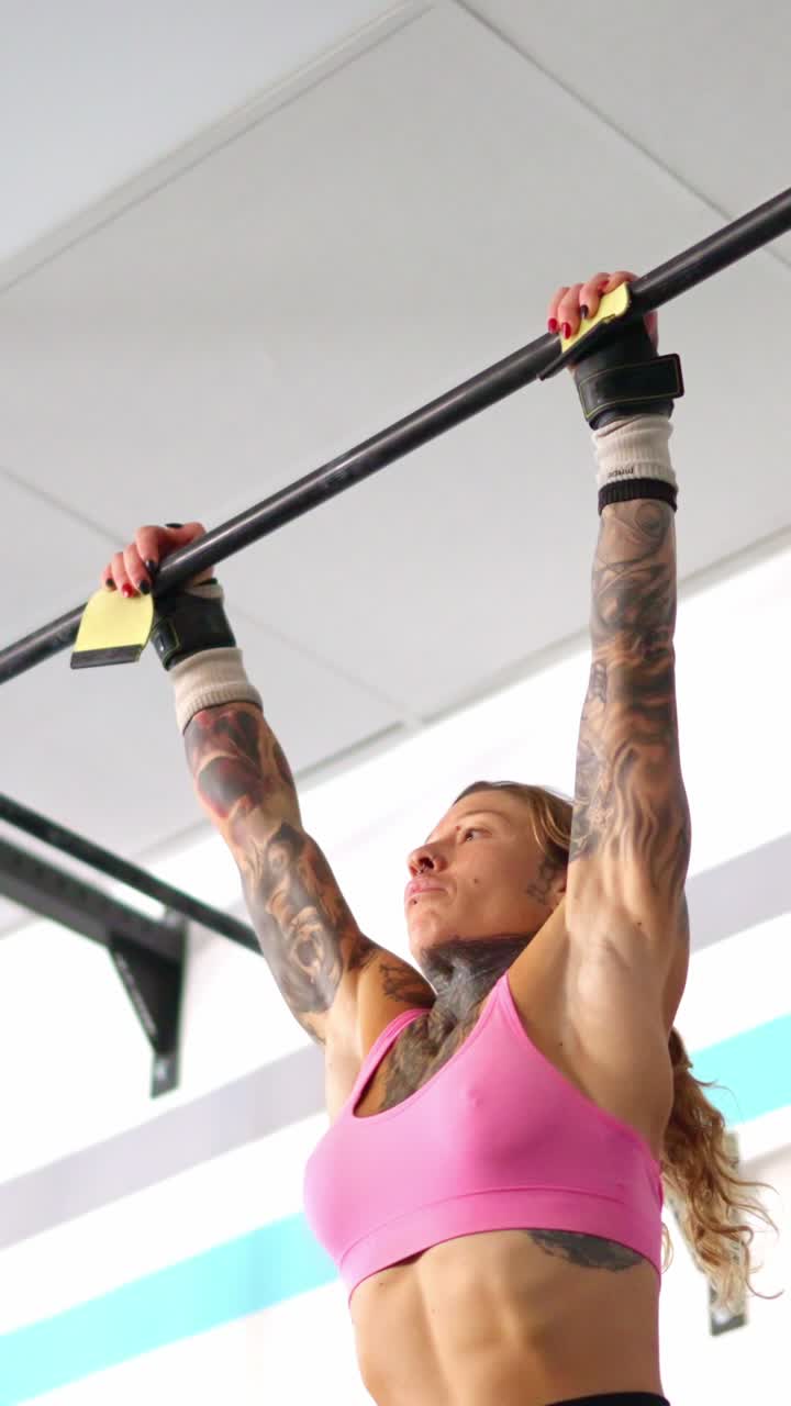 Athletic Woman Performing Core Workout on Pull-Up Bar