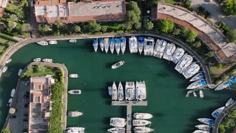 aerial view of a marina with yachts and coastal buildings