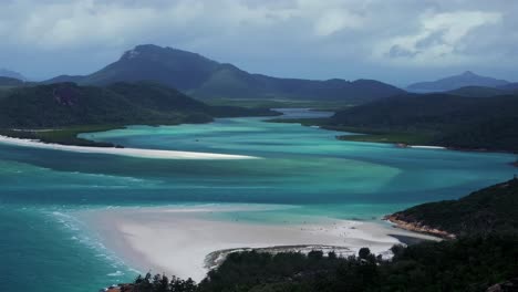 hill inlet lookout aerial drone scenic flight whitsundays qld australia sunny cloudy wind whitehaven beach great barrier reef island airlie national park clear turquoise ocean circle left parallax