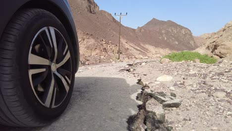 car traveling on a broken road