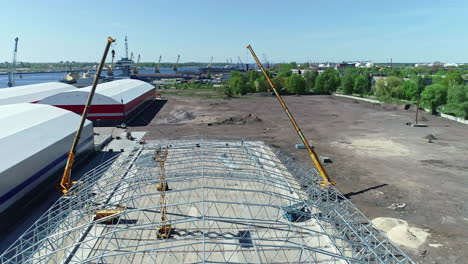 aerial footage of the under construction site with heavy machinery and equipment scattered throughout