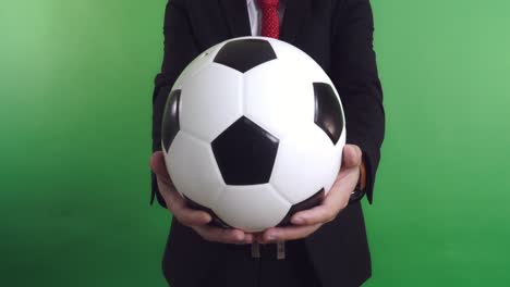 businessman giving a soccer ball, video in 4k