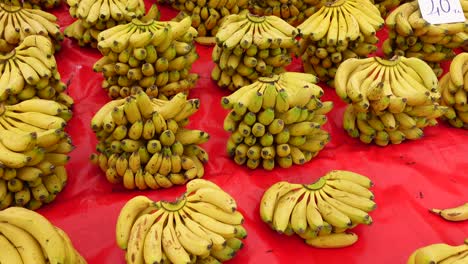 a table full of ripe bananas at a market