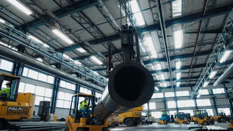 industrial warehouse with forklifts handling large pipes