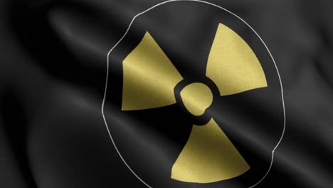 primer plano 4k ondeando la bandera del logo nuclear en fondo negro