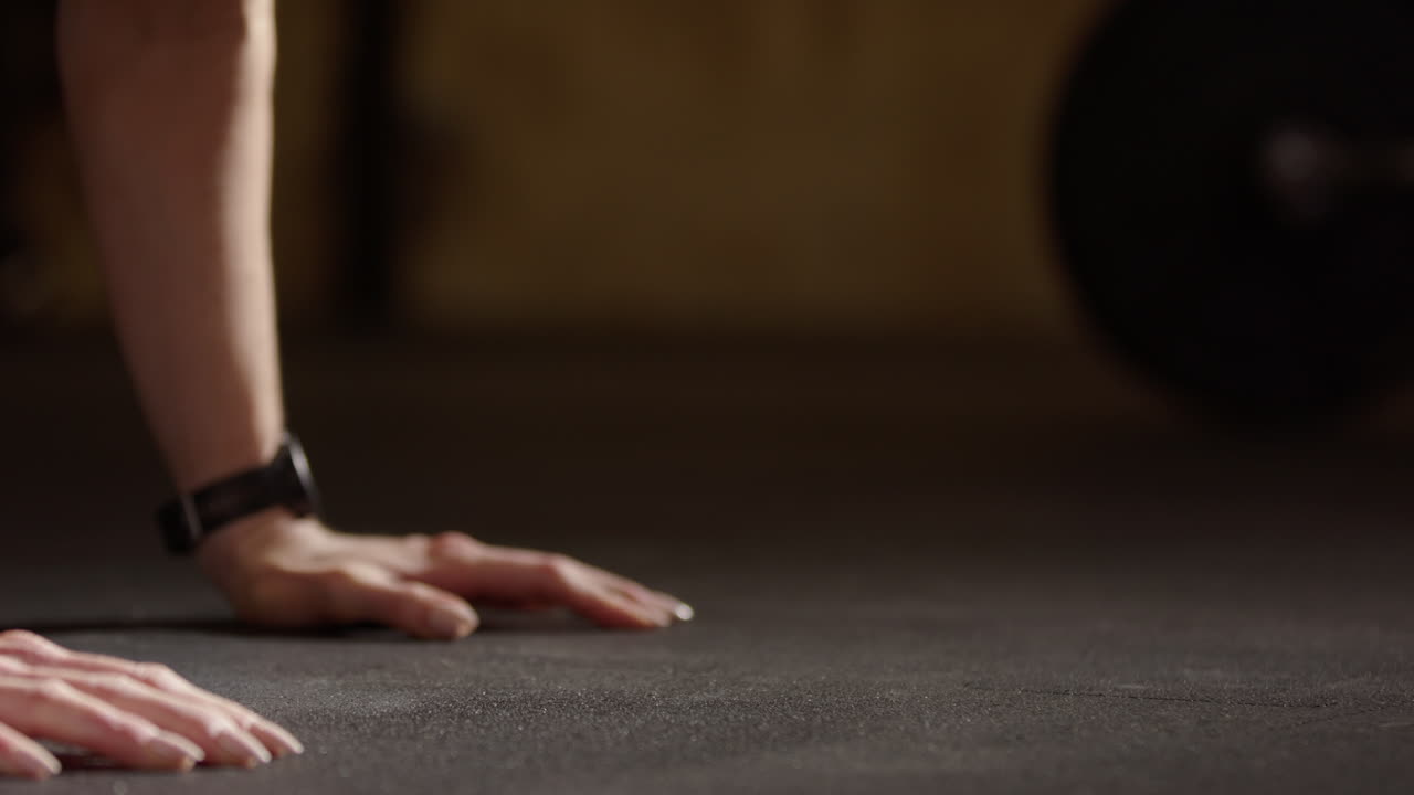 Low telephoto shot on chest and head of Swedish fitness model doing push-ups