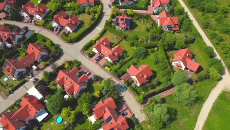 aerial view of residential houses neighborhood and apartment building complex at sunset