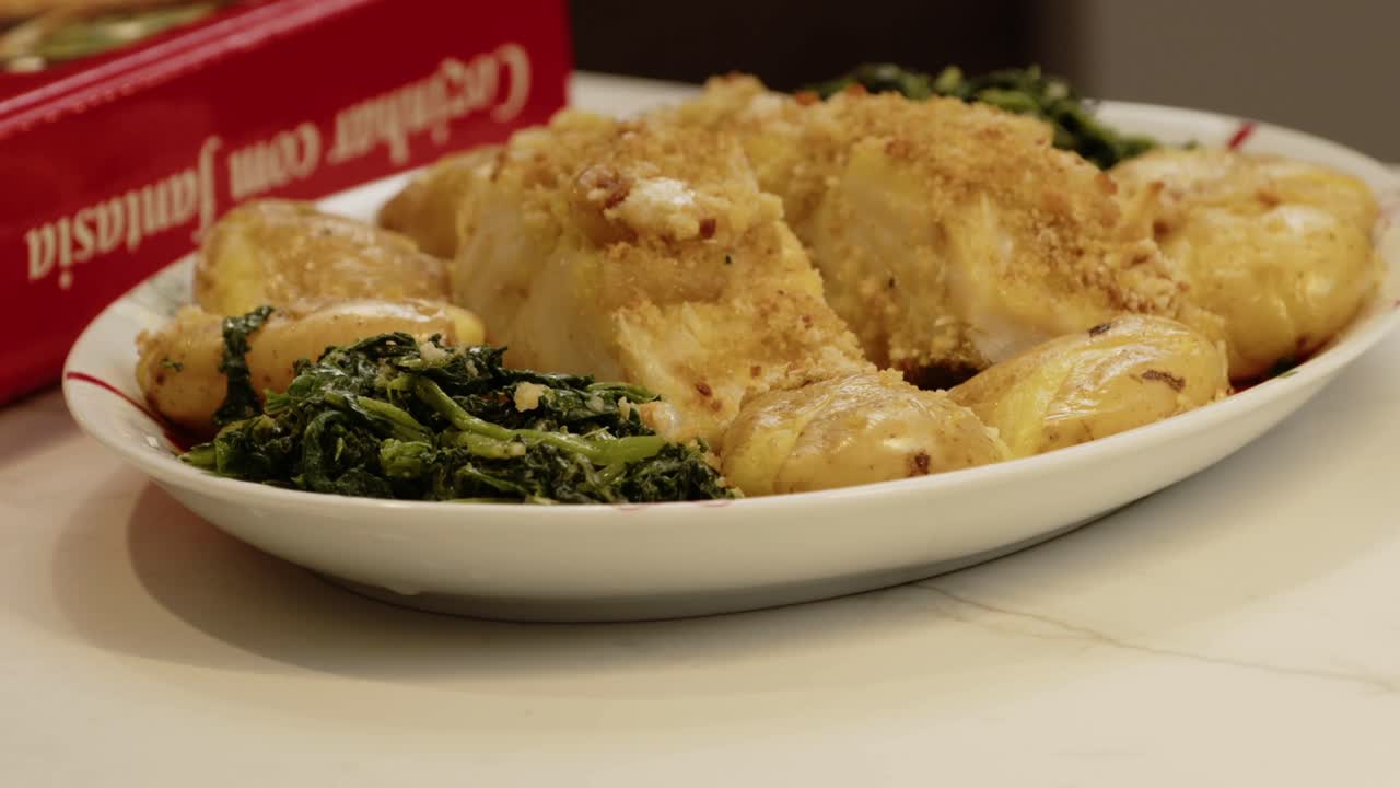 Close up of Portuguese codfish dish with potatoes and greens on a plate