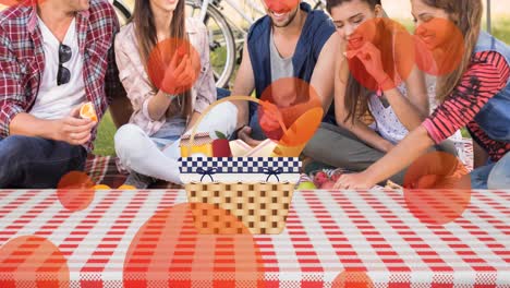 animation of pink spots over picnic basket on gingham and diverse friends in park