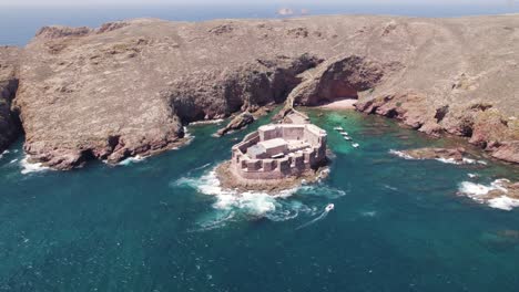 -Aerial-Reveal:-Berlengas-São-João-Baptista-Fort-on-island-coastline,-Portugal