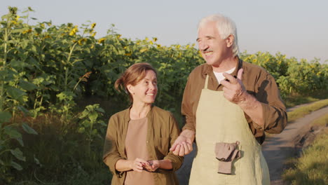 farmers strolling down rural field