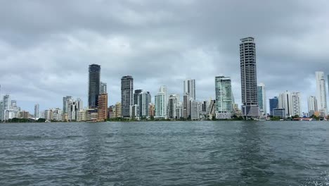 luxurious skyscrapers of cartagena de indias seeing from a motorboat at cloudy day