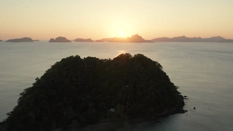 aerial shwoing depeldet island with sunset nearby el nido in the pilippines