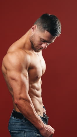 handsome muscular man posing. bodybuilder handsome man with muscular torso naked body. vertical video