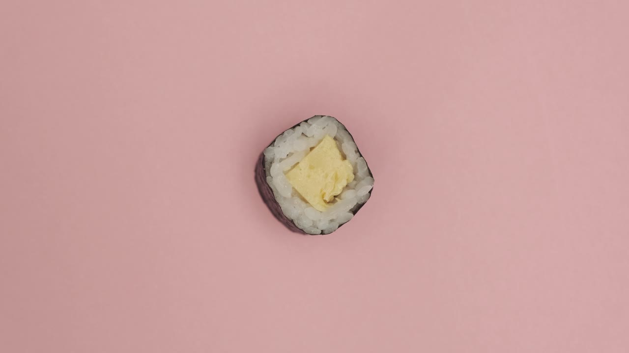 Sushi roll rotating on rosy background