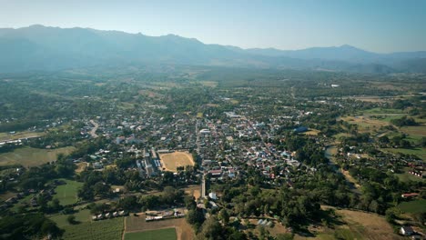 aerial scenic drone footage of the town of pai, thailand on a sunny day