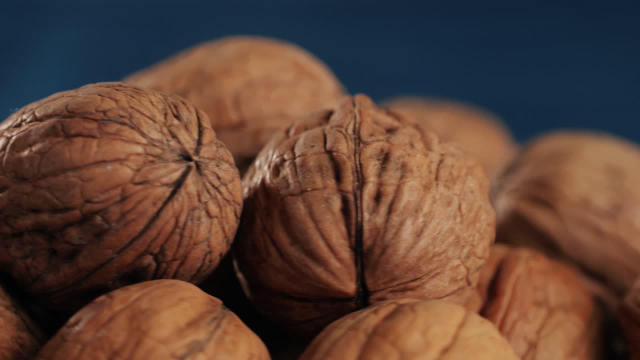 Walnuts in a shell rotating top view. Healthy snacks. Product rich in minerals and vitamins. High quality 4k footage