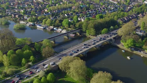 aerial footage looking over a busy transport section of the uk road network and rail lines