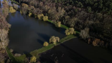 Dampiere-sur-Avre-pond-and-surrounding-rural-landscape,-France