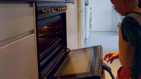 father and son opening oven door 4k