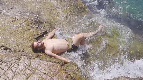 man sunbathing in the sea. slow motion