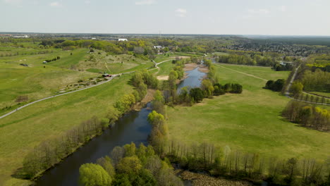 Panoramic-View-Of-Myslecinek-City-Park-With-Pond-And-Lush-Green-Field-In-Poland