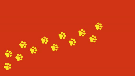 animation: a trail of yellow footprints on an orange background, a cat walking on a path, going from left to right