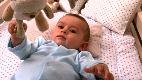 Baby-playing-with-mobile-in-his-crib