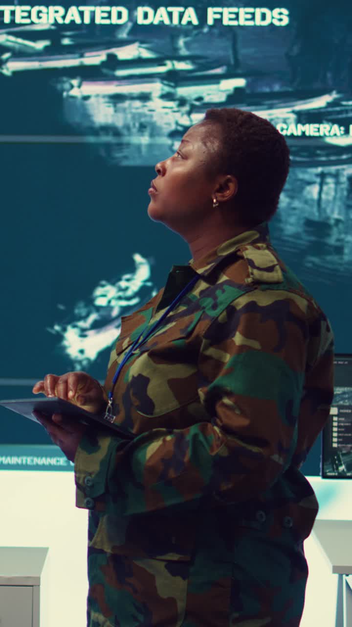 Military Woman Monitoring Integrated Data Feeds in Control Room