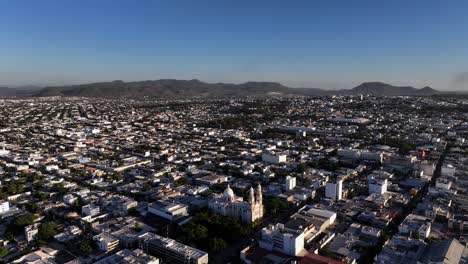 aerial overview of the cityscape of culiacan, in sunny mexico - circling, drone shot