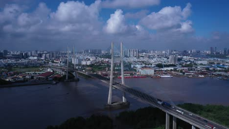 Aerial-view-of-Phu-My-Bridge-over-Saigon-river-with-road-and-river-transportation-on-a-sunny-day