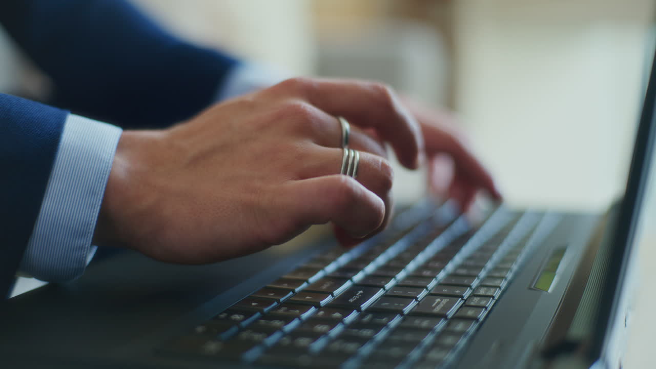 Man's Hand Typing on Keyboard