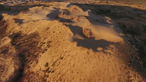 aerial view of massive sand dunes among rocky mountains in the arid region of the northern cape, south africa