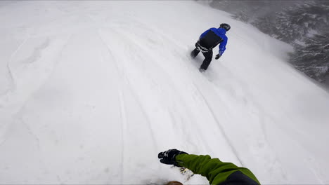 snowboarders ride away from the slid way into the snow. off-piste riding in the snowy mountains.