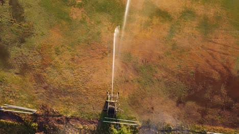 sprinkler watering grass in san isidro racecourse at sunset, buenos aires in argentina