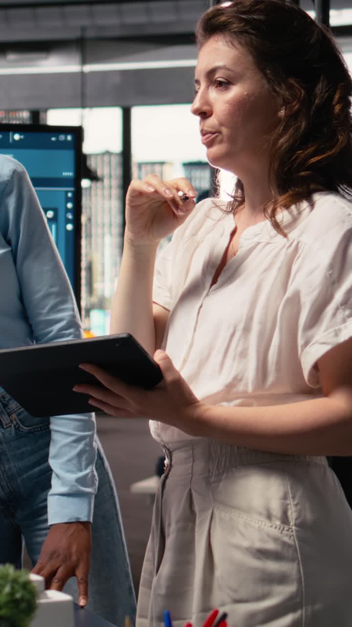 Vertical Video Diverse colleagues review structural plans for a property investment