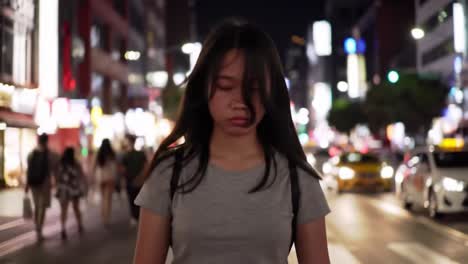 teenage girl walking at night in a city