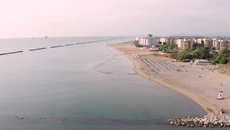 aerial view of sandy beach with umbrellas and gazebos