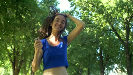 charming female runner listening music during jogging