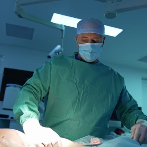 doctor in mask doing liposuction in clinic. professional surgeon perform an operation to a patient laying on surgical table. surgery treatment