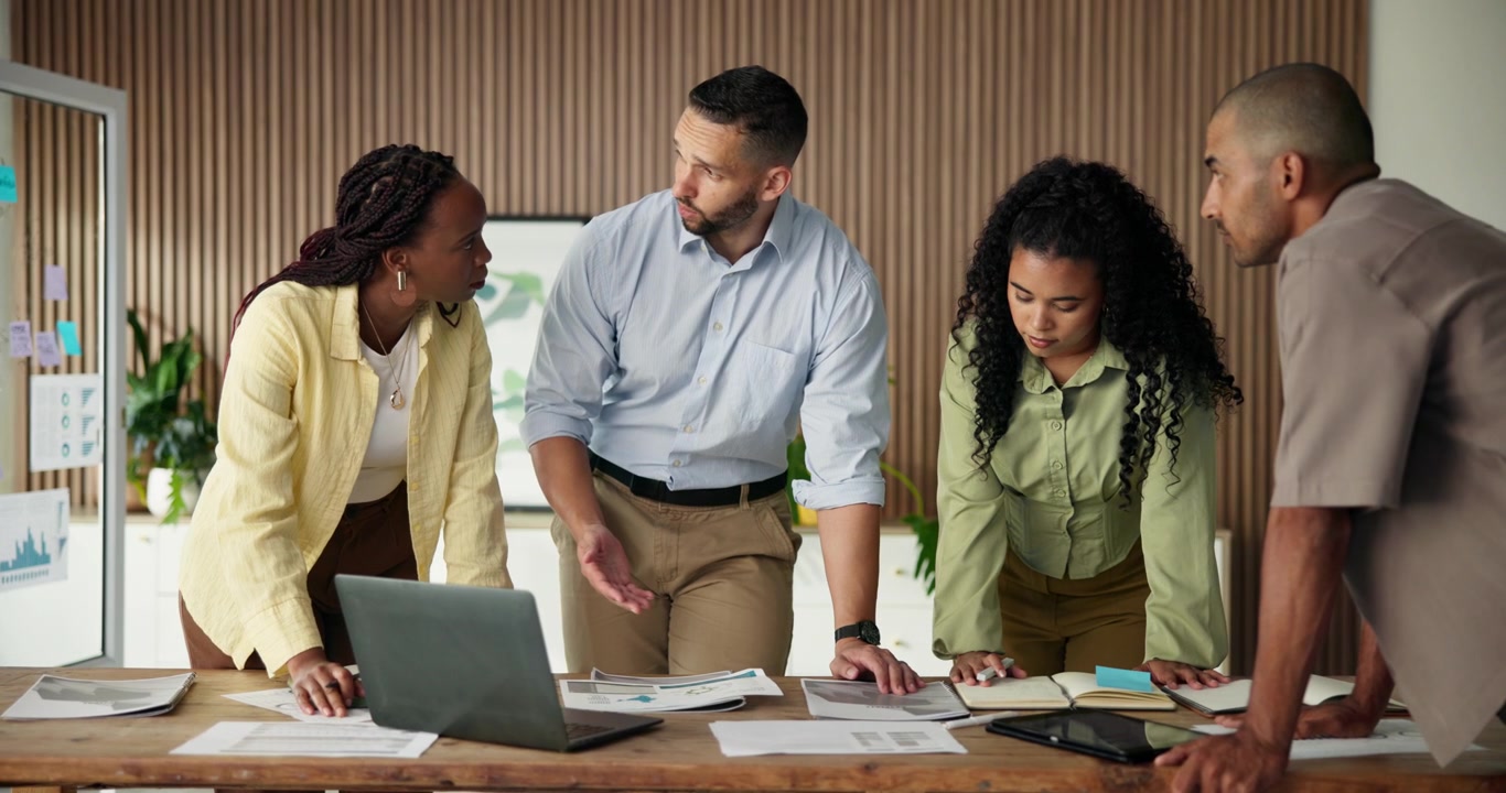 Diverse Business Team Collaborating on Project in Modern Office