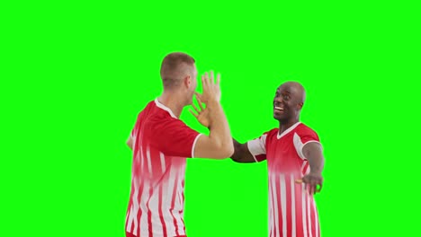 Video-of-two-diverse-male-soccer-players-cheering-on-green-screen-background