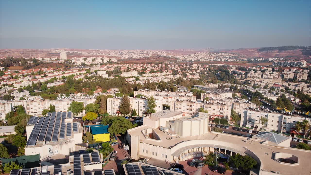 Aerial View of a Town with Solar Panels on Rooftops Under a Clear Sky